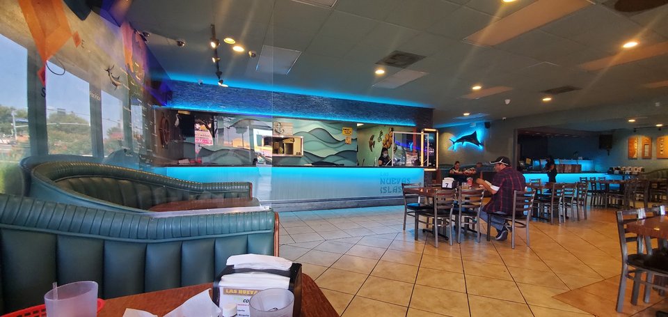 Seafood dishes beside chilled drinks and lime wedges.